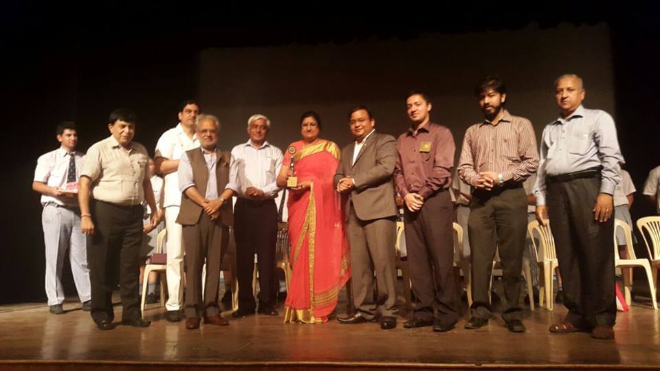 Initiative for social cause undertaken by businessman, people standing on stage
