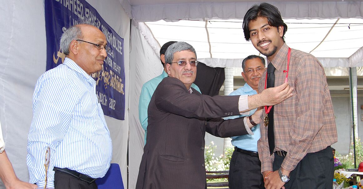 personality receiving awards, wearing medal