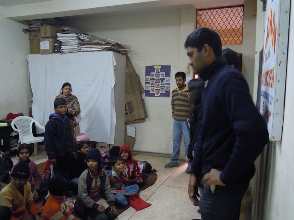 Initiative for social cause undertaken by businessman , man speaking to children