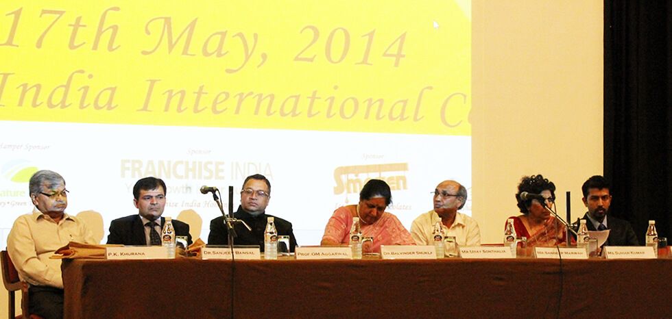 people sitting on a dais, Initiative for social cause undertaken by businessman