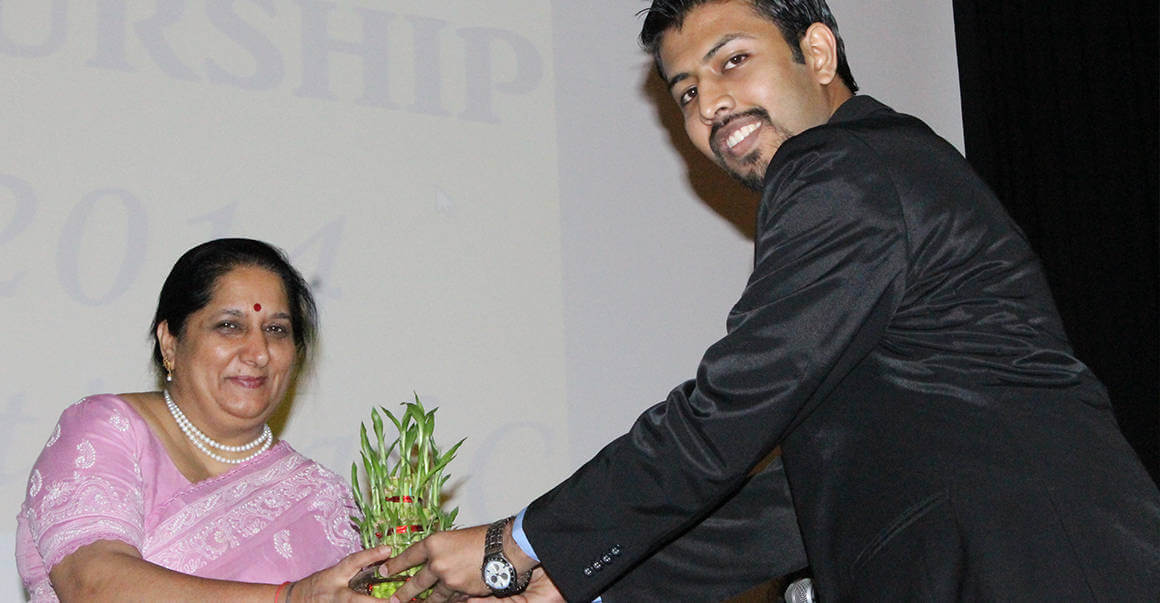 pink dress lady receiving plant image, uday sonthalia, man in black