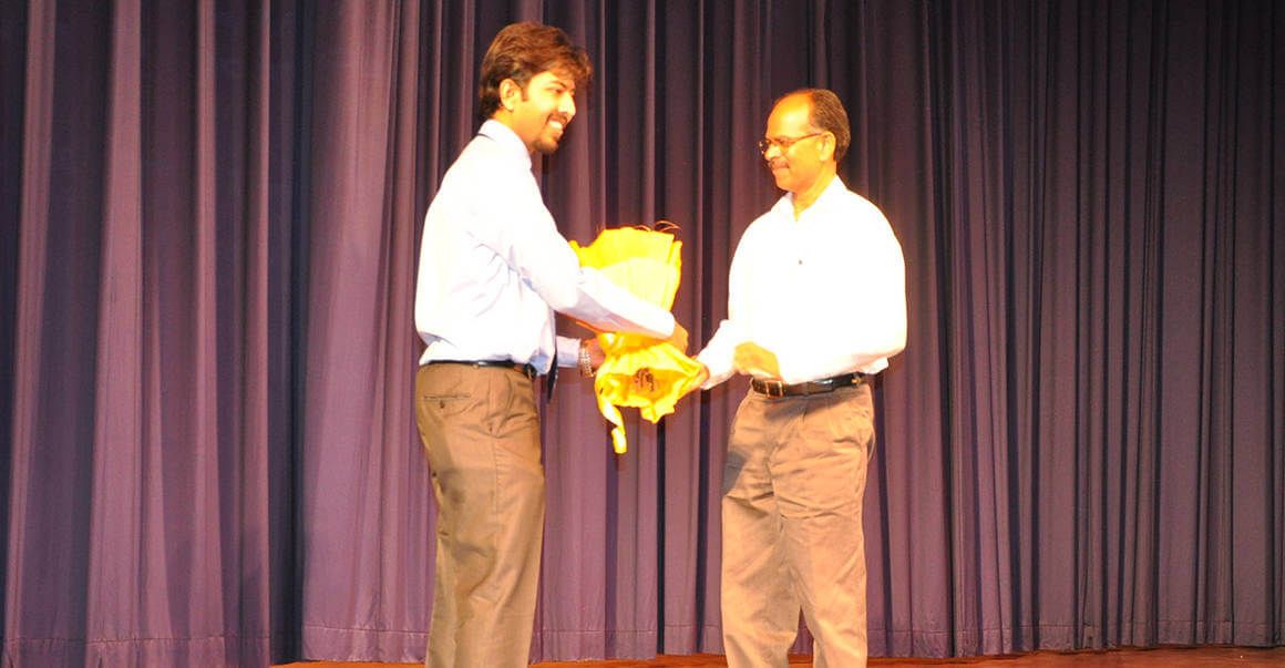 image of two men, presenting bouquet to a person image